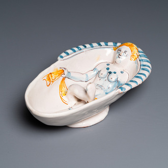 A polychrome French faience oval basin with a bathing woman, Nevers, 17th C.