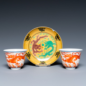 A pair of Chinese iron-red-decorated 'dragon' cups and a yellow-ground 'dragon' saucer, 19/20th C.