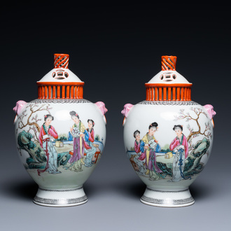 A pair of Chinese famille rose vases with reticulated covers, Qianlong mark, Republic