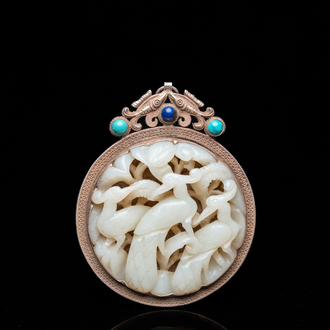 A Chinese reticulated jade 'three peacocks' carving in silver pendant, Qing