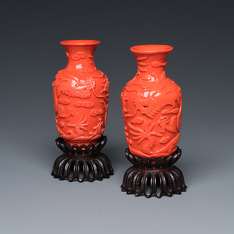 A pair of rare Chinese 'Beijing glass' vases imitating coral on wooden stands, 19/20th C.