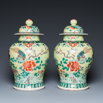 A pair of Chinese famille verte yellow-ground vases and covers, 19th C.