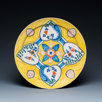 A polychrome Dutch Delft yellow-ground 'four hearts' dish, 18th C.