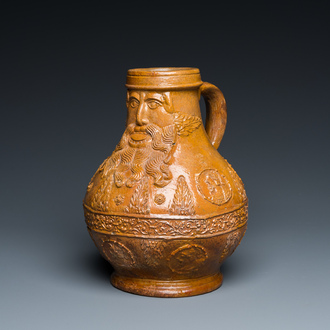 A rare German stoneware bellarmine jug with a bearded face sticking his tongue out, Cologne, 16th C.