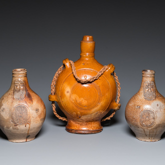 Two German stoneware bellarmine jugs and a pilgrim's flask, 17th C.