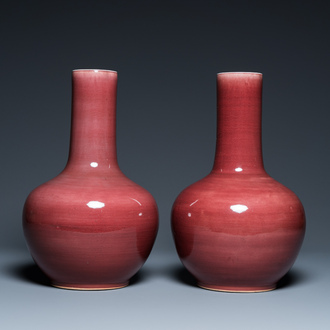 A pair of Chinese monochrome peachbloom-glazed bottle vases, 19th C.