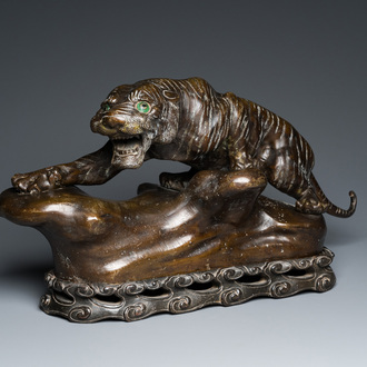 A large Vietnamese bronze tiger on a carved wooden stand, 19/20th C.