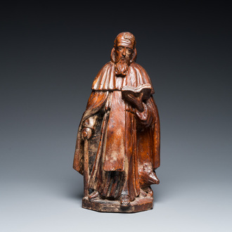 A carved oak group of the reading Saint Anthony with a pig, 17th C.