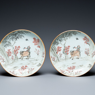 A pair of Chinese iron-red and grisaille 'boy on buffalo' plates, Qianlong