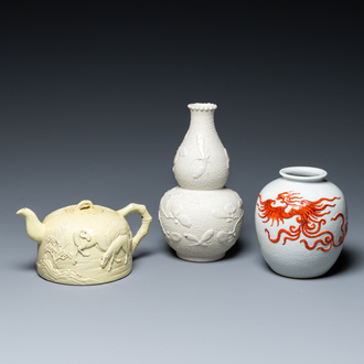 A Chinese yellow-glazed biscuit teapot, a white-glazed biscuit double gourd vase and an iron-red 'phoenix' jar, 20th C.