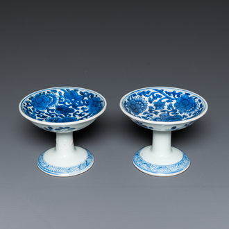 A pair of Chinese blue and white 'lotus scroll' stem cups, Kangxi