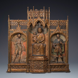 A large Spanish gilt and polychromed wooden tryptich retable with Saint John the Baptist, the Virgin Mary and Saint Roch, 1st half 16th C.