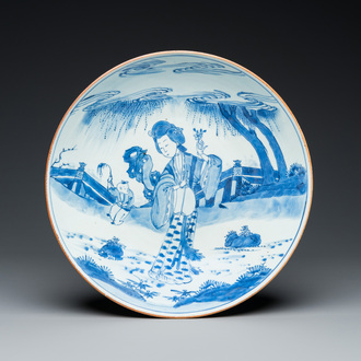 A large Chinese blue and white 'lady and boy' dish, Kangxi mark and of the period
