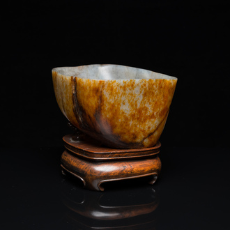 A Chinese hollowed jade libation cup on wooden stand, probably Qing