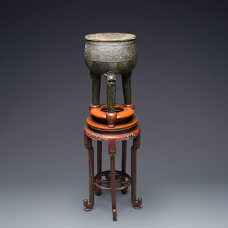 A large Chinese tripod censer on wooden base and display stand, Qing