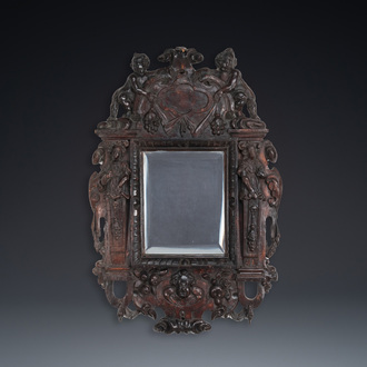 A carved oak mirror with cherubs and caryatids, the Low Countries, 17th C.