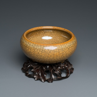A Chinese crackle-glazed tripod censer on carved wooden stand, 19th C.