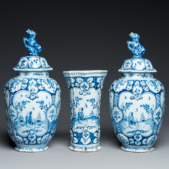 A Dutch Delft blue and white chinoiserie garniture of three vases, 18th C.