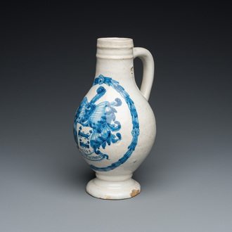 A Portuguese blue and white armorial ewer inscribed Jacob Schröder, Lisbon, dated 1644