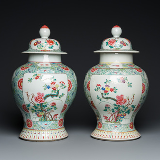 A pair of Chinese famille rose vases and covers, 19th C.