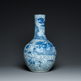 A Chinese blue and white 'dragons' bottle vase, 19th C.