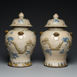 A pair of Vietnamese Bat Trang stoneware 'dragon' vases and covers, 19th C.
