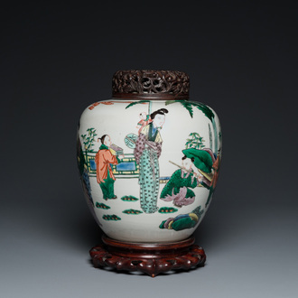 A Chinese famille verte jar with wooden cover and stand, 19th C.