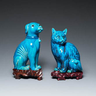 A Chinese turquoise-glazed cat and a dog on wooden stands, 19th C.