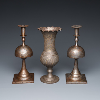 A pair of Qajar damascened candlesticks and a vase, Persia, 19th C.