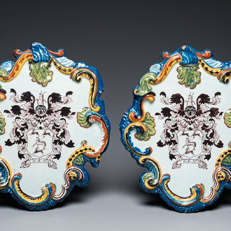 A pair of polychrome Dutch Delft armorial plaques dated 1767