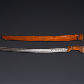 An Indonesian sword in wooden scabbard, dated 1891 and inscribed TJIPATJING