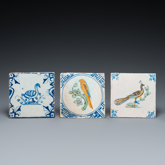 Two polychrome Dutch Delft tiles with a parrot and a peacock, and a blue and white one with a goose, 17th C.