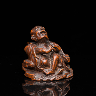 A Chinese bamboo carving of a laughing Luohan, 18th C.