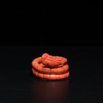 A Chinese red coral bracelet with a dragon's or snake's head, 19th C.