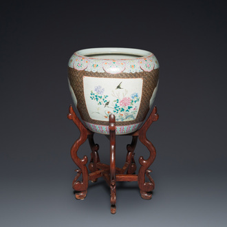 A large Chinese famille rose fish bowl on wooden stand, 19th C.