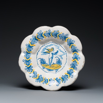 A blue, white and yellow Dutch Delftware dish with a putto holding a falcon, Delft or Haarlem, 17th C.