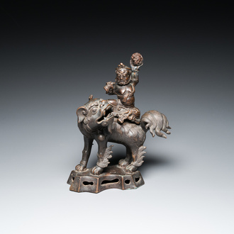 A Chinese bronze censer and cover in the shape of a Luohan on a Buddhist lion, late Ming/early Qing