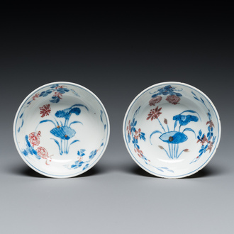 A pair of Chinese blue, white and copper-red semi-eggshell bowls, Xuande mark, Wanli