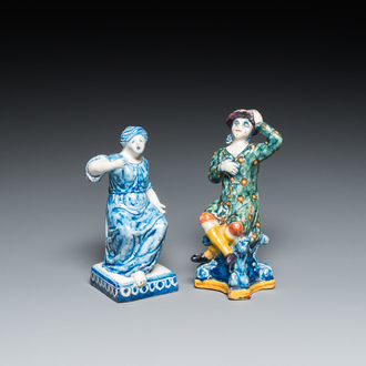 A polychrome Dutch Delft figure of a seated man and a blue and white one of a seated lady, 18th C.