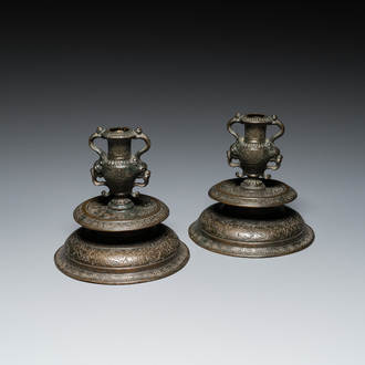 A pair of Italian engraved bronze candlesticks, probably Venice, 16th C.