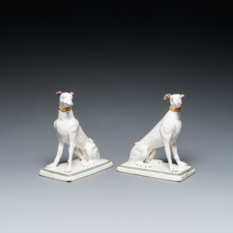 A pair of polychrome Brussels faience greyhounds, 18th C.