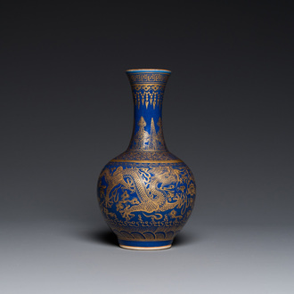 A Chinese monochrome blue gilt-decorated 'dragons' bottle vase, Qianlong mark, 19th C.