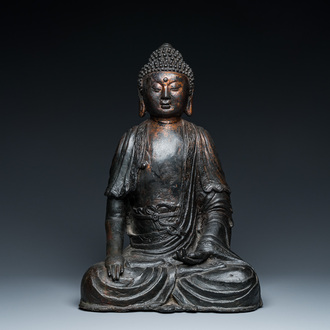 A large Sino-Tibetan bronze Buddha with traces of gilding, Ming
