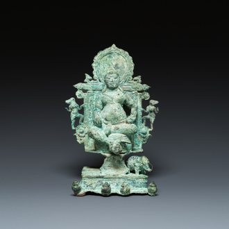 A bronze group with Kubera on a throne, Central Java, Indonesia, 11/12th C.