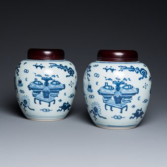 A pair of Chinese blue and white ‘antiquities’ jars with wooden covers, Kangxi