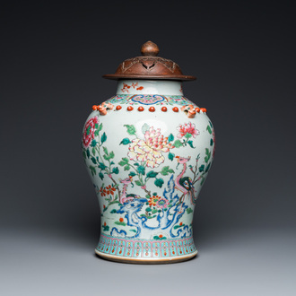 A Chinese famille rose vase with wooden cover, 19th C.