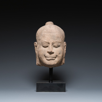 A Khmer stone head of Jayavarman VII in Bayon-style, Cambodia, probably 13th C.