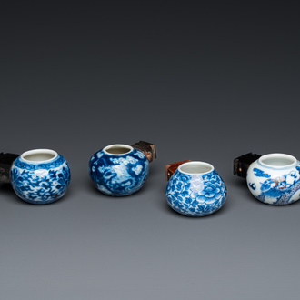 Four Chinese blue, white and copper-red bird feeders, 19th C.