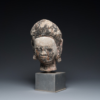 A Khmer stone head with traces of polychromy, Cambodia or Thailand, 13/16th C.