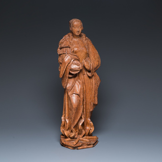 A Flemish carved oak sculpture of a female saint on a pyre, Brabant region, first half 16th C.